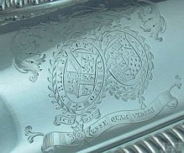 detail of armorial engraving from antique silver entree dish